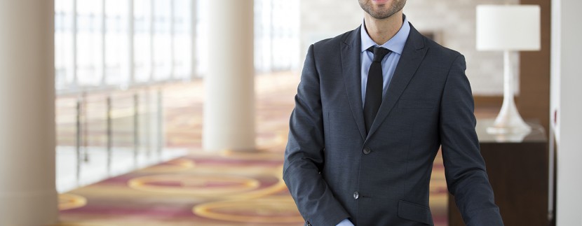 hotel broker standing in lobby of hotel